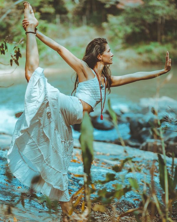 Woman in a graceful yoga pose representing harmony and balance.